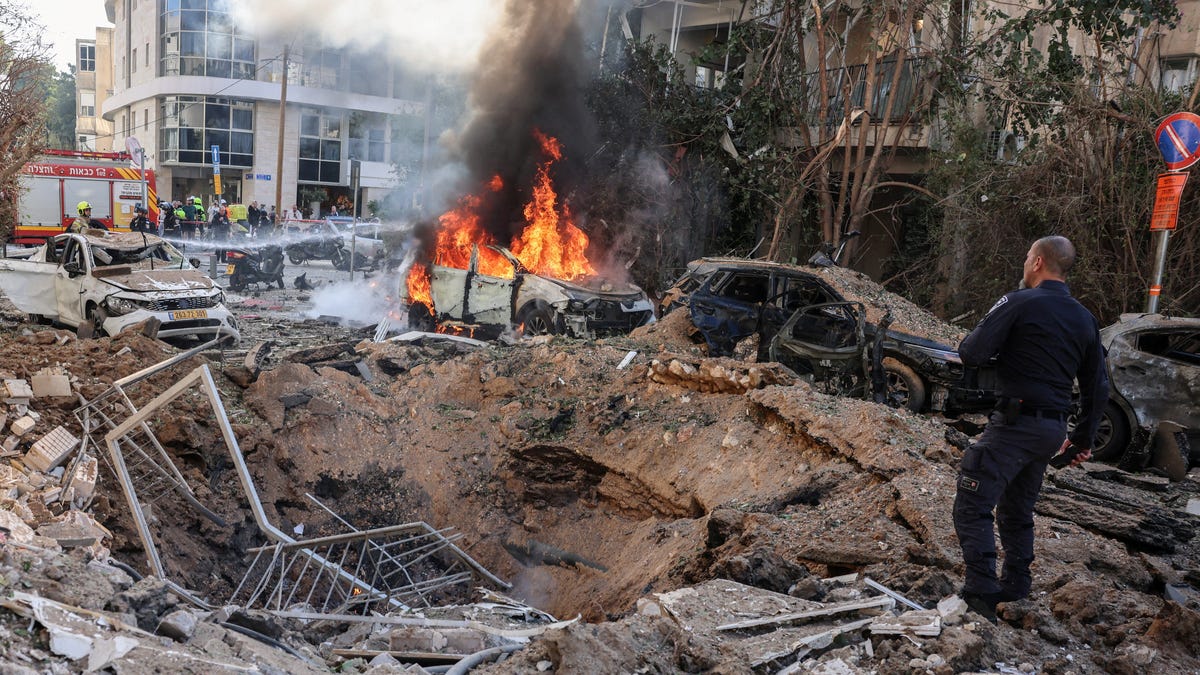 Emergency personnel respond at a site following Iranian missile barrages in central Israel, amid the U.S.-Israel conflict with Iran, in Tel Aviv, Israel, March 24, 2026.