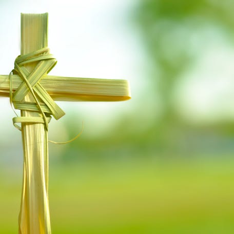 Cross made out of palm fronds.