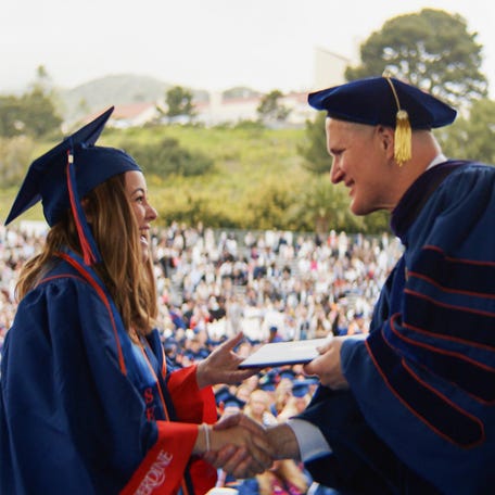 Pepperdine University President Jim Gash congratulates a graduate at commencement in April 2025.