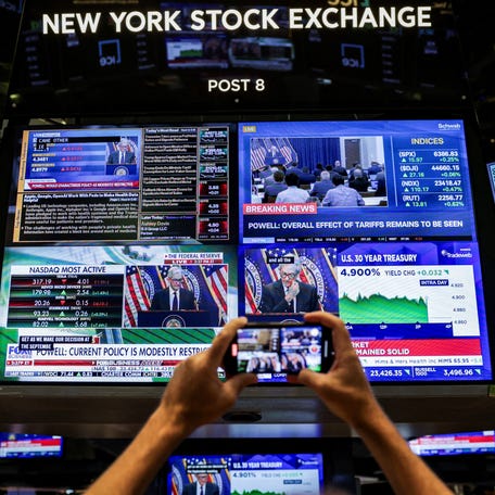 A screen on the New York Stock Exchange floor displays a news conference by Federal Reserve Chair Jerome Powell on July 30, 2025.