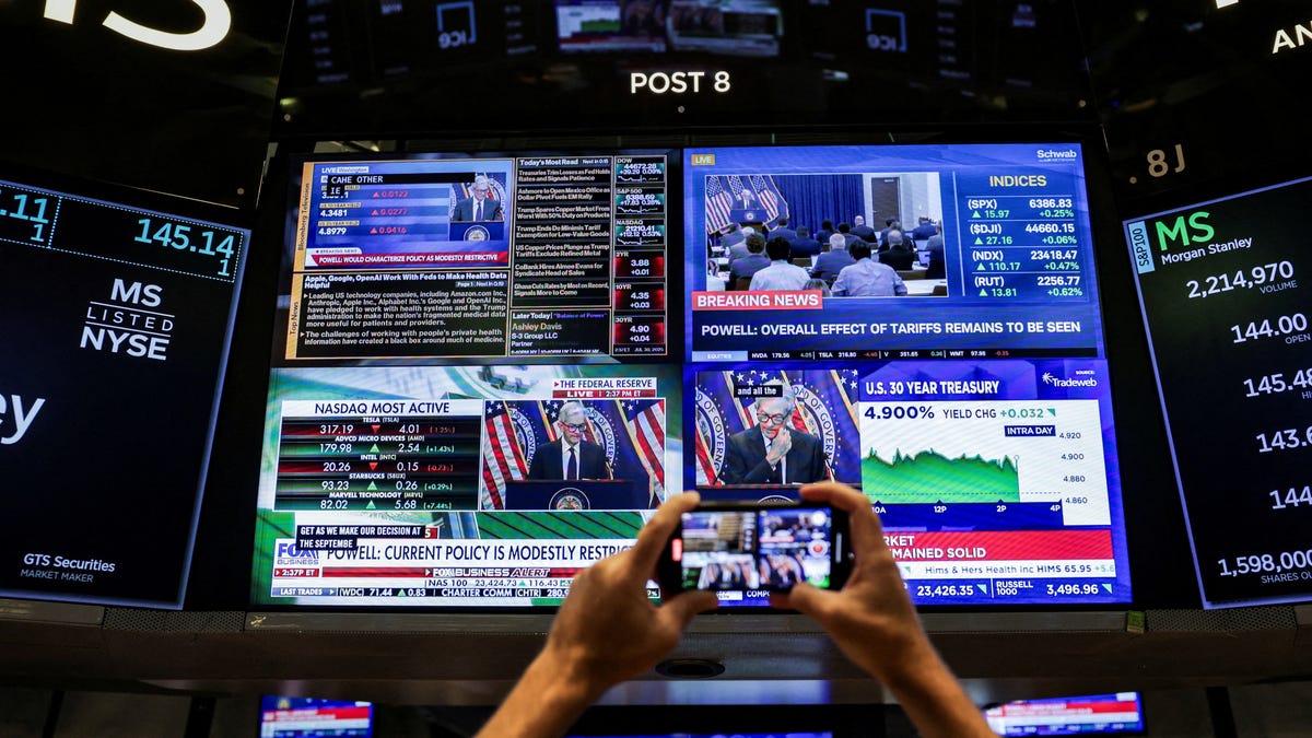 A screen on the New York Stock Exchange floor displays a news conference by Federal Reserve Chair Jerome Powell on July 30, 2025.
