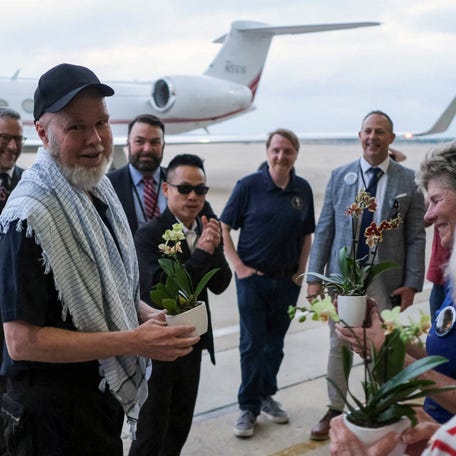 American Dennis Coyle, who was detained by the Afghan Taliban government for more than year, is greeted as he arrives at Joint Base San Antonio in San Antonio, Texas, on March 25, 2026.