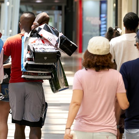 Shoppers carry bags at the Galleria Dallas mall in Dallas, Texas, U.S., on Monday, May 4, 2020. Texas Governor Greg Abbott announced that all restaurants, malls, and stores could reopen on May 1, limited to 25% occupancy. Photographer: Cooper Neill/Bloomberg via Getty Images