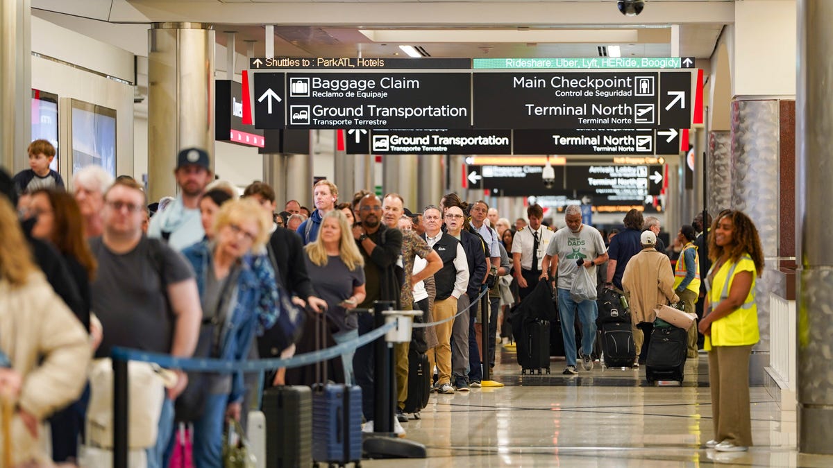 Travelers wait in long lines at Atlanta Hartsfield-Jackson International Airport on March 26, 2026.