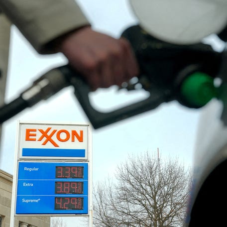 FILE PHOTO: A man pumps gas at an Exxon station as the price of oil and gas has surged amid the U.S.-Israeli conflict with Iran, in Washington, D.C., U.S., March 5, 2026. REUTERS/Ken Cedeno/File Photo