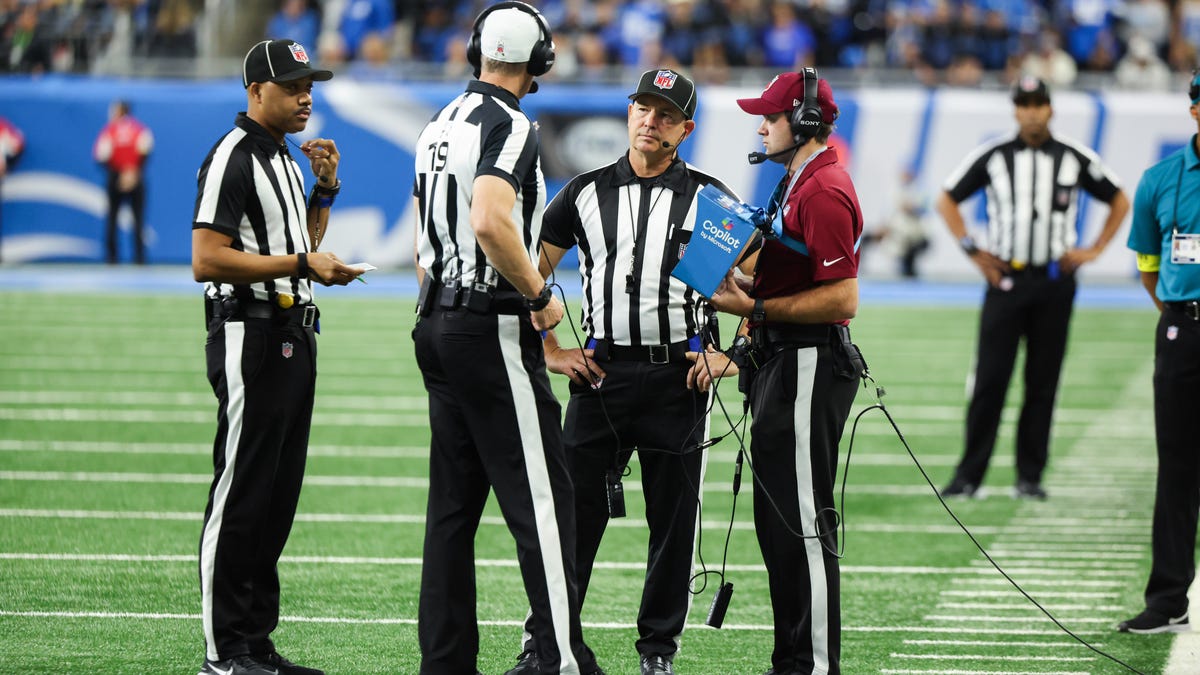 Referees review an interception during the second quarter of a game between the Minnesota Vikings and Detroit Lions on Nov. 2, 2025, at Ford Field in Detroit, Michigan.