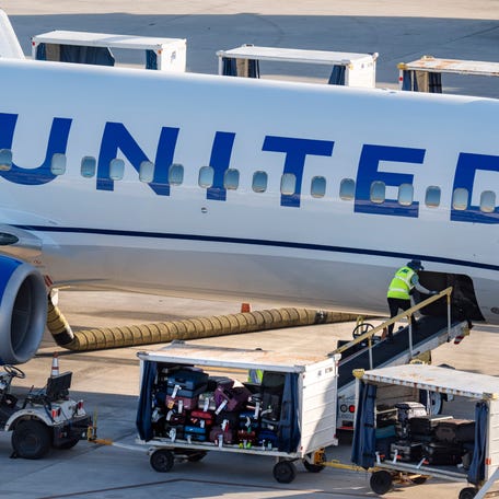 Luggage is unloaded from a United Airlines plane on March 11, 2026, in West Palm Beach, Florida.