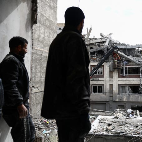A man looks at a residential building damaged by a strike, amid the U.S.-Israeli conflict with Iran, in Tehran, Iran, March 27, 2026.