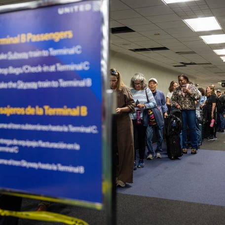 HOUSTON, TEXAS - MARCH 27: Travelers wait in line at Terminal A at George Bush Intercontinental Airport on March 27, 2026 in Houston, Texas. The Senate unanimously approved funding for the Department of Homeland Security, excluding money for immigration enforcement and deportation operations.
