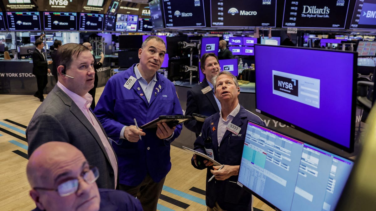 Traders work on the floor at the New York Stock Exchange (NYSE) in New York City, U.S., March 24, 2026. REUTERS/Jeenah Moon/File Photo
