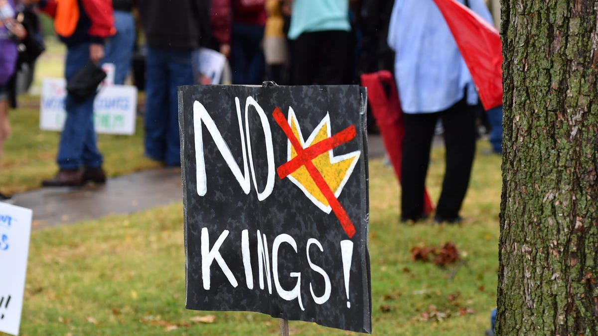 No Kings signs are displayed during a protest at Hamilton Park in Wichita Falls on Saturday, Oct. 18, 2025.