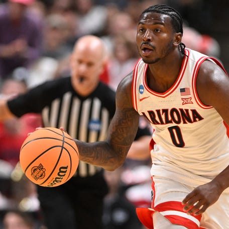 Arizona Wildcats guard Jaden Bradley (0) dribbles the ball against the Arkansas Razorbacks in the first half during a Sweet Sixteen game of the West Regional of the men's 2026 NCAA Tournament at SAP Center.