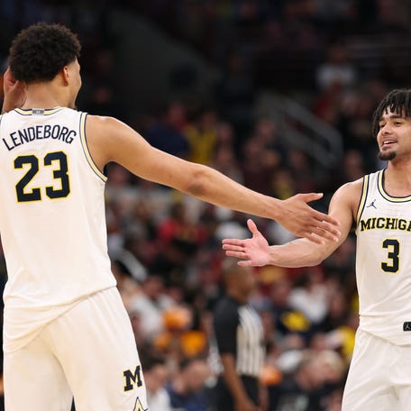 CHICAGO, ILLINOIS - MARCH 27: Elliot Cadeau #3 and Yaxel Lendeborg #23 of the Michigan Wolverines celebrate during the second half against the Alabama Crimson Tide in the Sweet Sixteen of the 2026 NCAA Men's Basketball Tournament at the United Center on March 27, 2026 in Chicago, Illinois. (Photo by Michael Reaves/Getty Images)