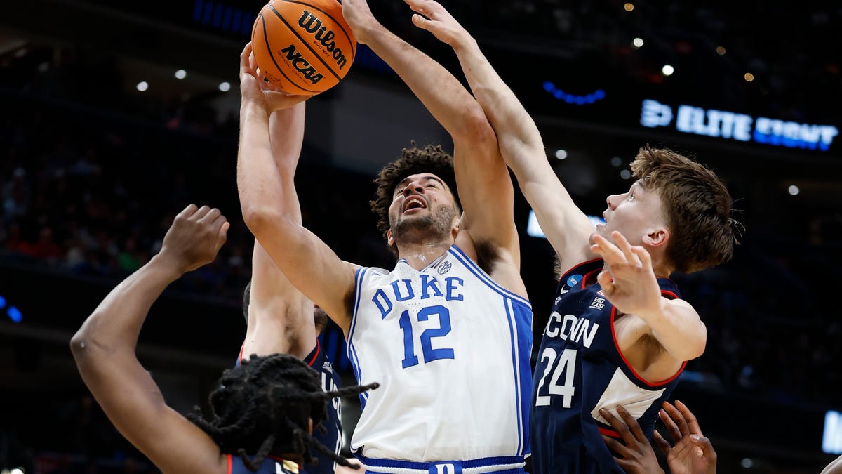 Mar 29, 2026; Washington, DC, USA; Duke Blue Devils forward Cameron Boozer (12) goes to the basket against UConn Huskies guard Braylon Mullins (24) in the first half during an Elite Eight game of the East Regional of the men's 2026 NCAA Tournament at Capital One Arena. Mandatory Credit: Amber Searls-Imagn Images