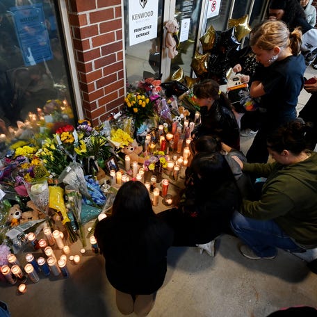 Students gather around a makeshift memorial at the school entrance during a candlelight vigil on Saturday, March 28, 2026, in Clarksville, Tennessee.