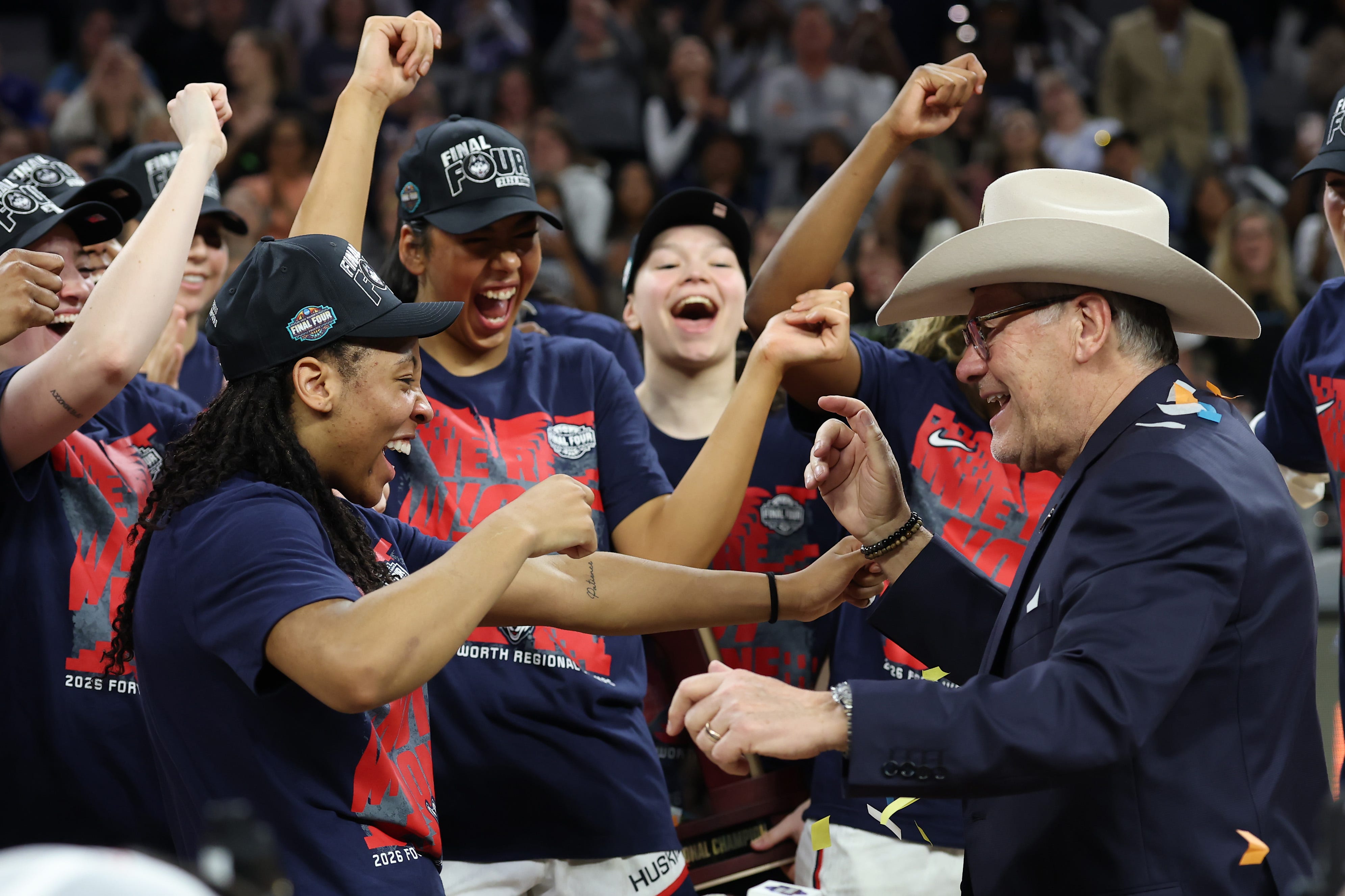 UConn coach Geno Auriemma celebrated his team's Elite Eight win with a cowboy hat and dance moves, surprising his players.