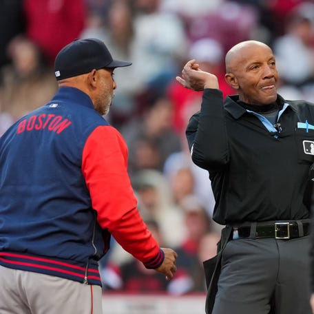 MLB umpire CB Bucknor (54) ejects Boston Red Sox manager Alex Cora (13) during the game against the Cincinnati Reds in the eighth inning at Great American Ball Park in Cincinnati, Ohio on March 28, 2026.