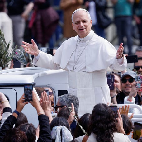 Pope Leo XIV gestures as he leaves after Palm Sunday Mass in Saint Peter's Square at the Vatican, March 29, 2026. REUTERS/Remo Casilli