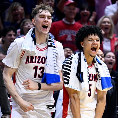 Arizona Wildcats center Motiejus Krivas (13) and guard Brayden Burries (5) and forward Tobe Awaka (30) react with the bench in the second half against the LIU Sharks during a first round game of the men's 2026 NCAA Tournament at Viejas Arena.