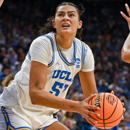 Duke forward Toby Fournier (35) defends against UCLA center Lauren Betts (51).