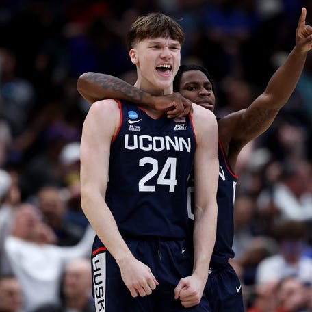 Braylon Mullins #24 celebrates with Malachi Smith #0 of the UConn Huskies after shooting the game-winning three point basket during the second half of a game against the Duke Blue Devils in the Elite Eight of the 2026 NCAA Men's Basketball Tournament at Capital One Arena on March 29, 2026 in Washington, DC.