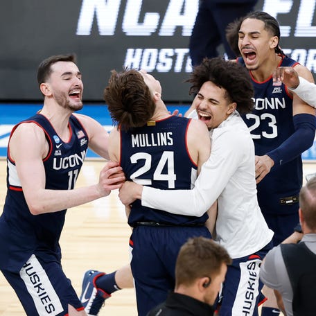 UConn Huskies forward Alex Karaban (11) celebrates with UConn Huskies guard Braylon Mullins (24) after defeating the Duke Blue Devils in an Elite Eight game of the East Regional of the men's 2026 NCAA Tournament at Capital One Arena.