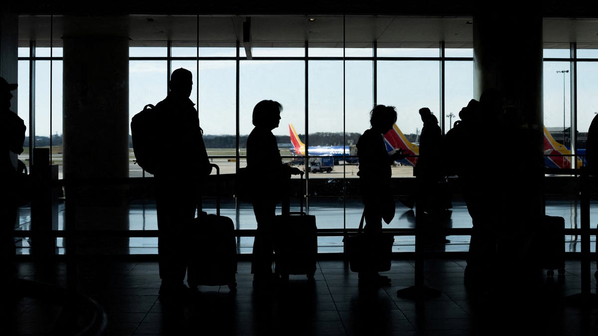 Passengers wait in a TSA security checkpoint queue that stretches through Baltimore/Washington International Thurgood Marshall Airport (BWI) on March 29, 2026.