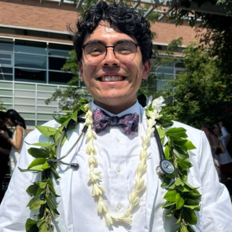 Trevor Tamura smiles at his white coat ceremony. 