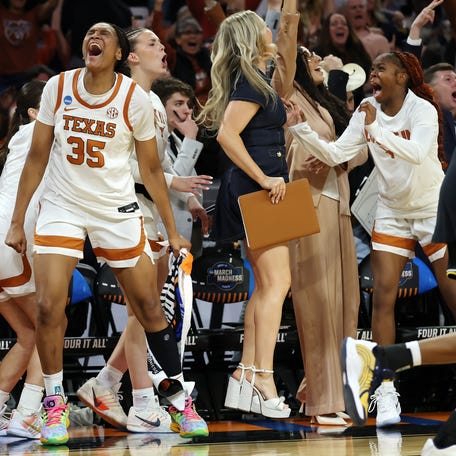 Texas forward Madison Booker celebrates on the bench in the fourth quarter.