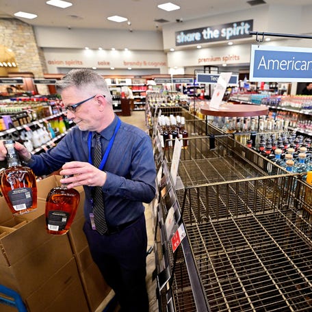 Senior Manager Trevor Hill removes the last bottles of American Whiskey from the shelves at the Cambie BC Liquor in Vancouver, British Columbia, Canada March 10, 2025.