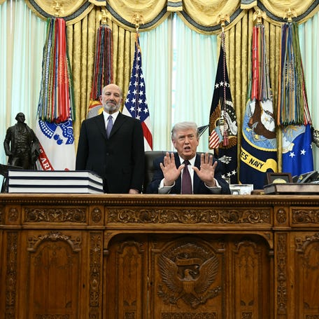 President Donald Trump (R) speaks as Commerce Secretary Howard Lutnick (L) looks after signing an executive order in the Oval Office of the White House in Washington, DC, on March 31, 2026.
