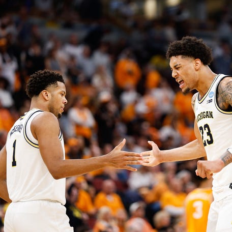 Mar 29, 2026; Chicago, IL, USA; Michigan Wolverines forward Yaxel Lendeborg (23) celebrates with guard Trey McKenney (1) in the first half against the Tennessee Volunteers during an Elite Eight game of the Midwest Regional of the men's 2026 NCAA Tournament at United Center. Mandatory Credit: Kamil Krzaczynski-Imagn Images