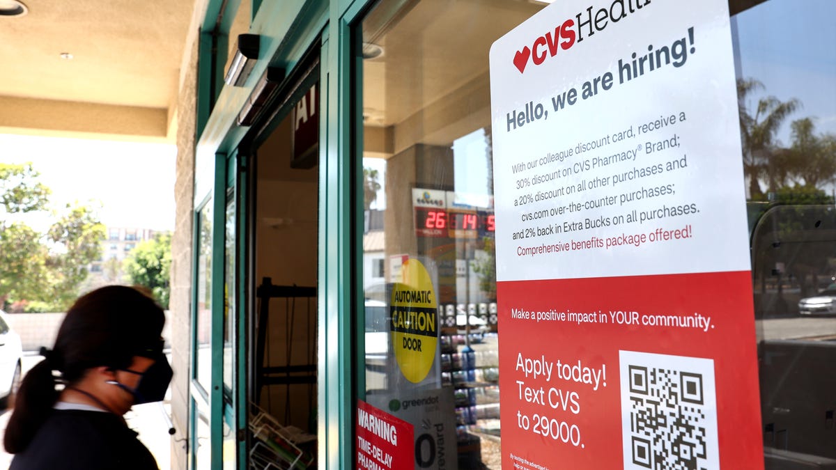 A sign reads, 'Hello, we are hiring!' in front of a CVS store in Los Angeles, on August 8, 2022. (Photo by Mario Tama/Getty Images)