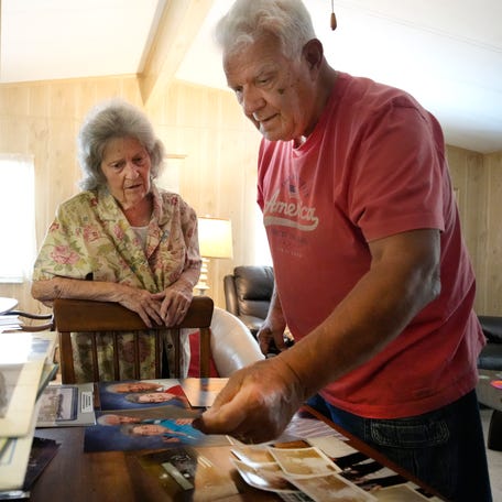 Paul and Marie Laramee sort through old photographs in their Sarasota home while looking for wedding photos for this story.