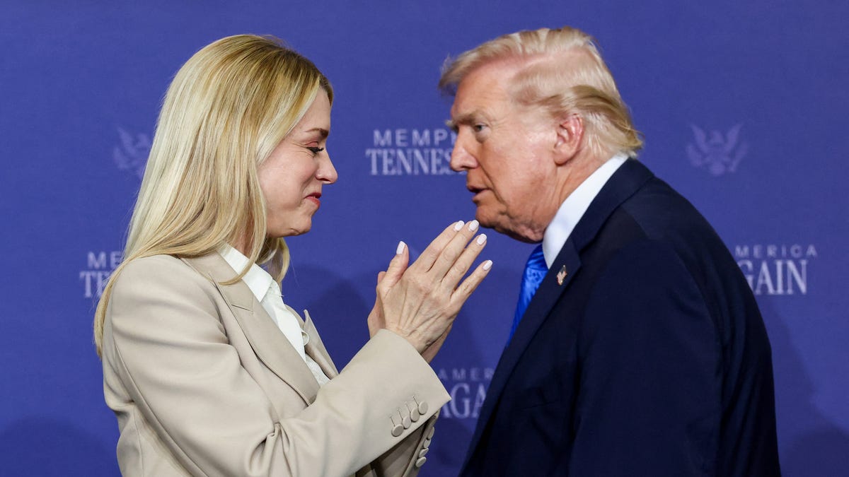 Attorney General Pam Bondi applauds as President Donald Trump walks past her at a roundtable on public safety at Memphis Air National Guard Base in Memphis, Tennessee, on March 23, 2026.
