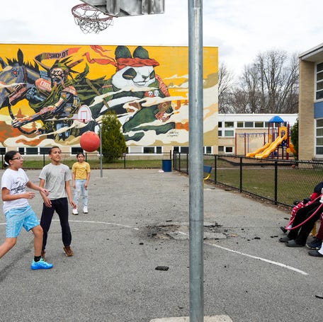 Students play basketball and socialize during recess April 1 at the Worcester Dual Language Magnet School.