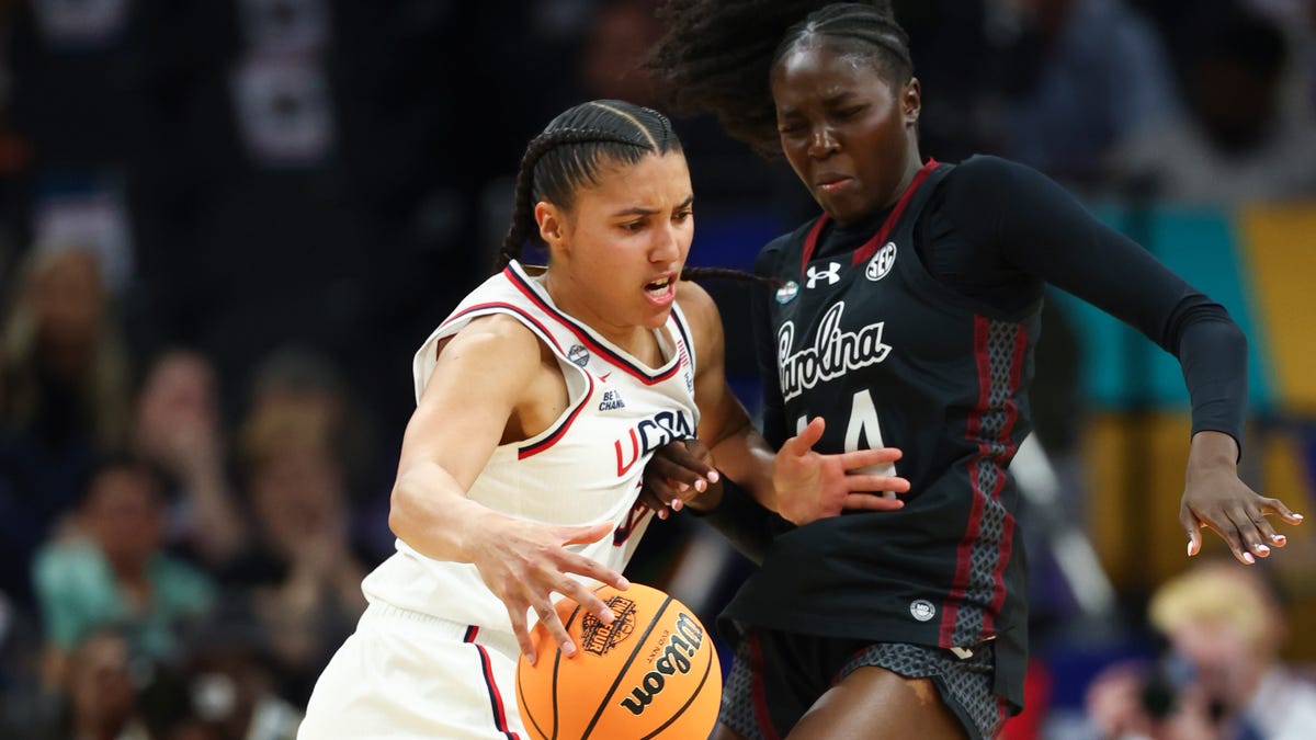 UConn Huskies guard Azzi Fudd (35) controls the ball against South Carolina Gamecocks guard Agot Makeer (44) during the first half of their national semifinal at Mortgage Matchup Center in Phoenix on April 3, 2026.