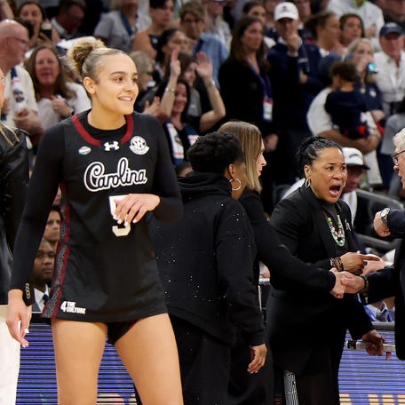 PHOENIX, ARIZONA - APRIL 03: Head coach Dawn Staley of the South Carolina Gamecocks and head coach Geno Auriemma of the UConn Huskies exchange words during the fourth quarter in the Final Four of the NCAA Women's Basketball Tournament at Mortgage Matchup Center on April 03, 2026 in Phoenix, Arizona. (Photo by Christian Petersen/Getty Images)
