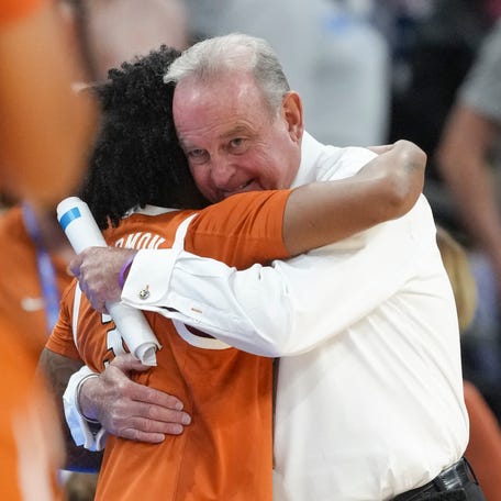 Apr 3, 2026; Phoenix, AZ, USA; Texas Longhorns head coach Vic Schaefer hugs guard Rori Harmon (3) during the second half of a semifinal of the Final Four of the women's 2026 NCAA Tournament against the UCLA Bruins at Mortgage Matchup Center. Mandatory Credit: Kirby Lee-Imagn Images