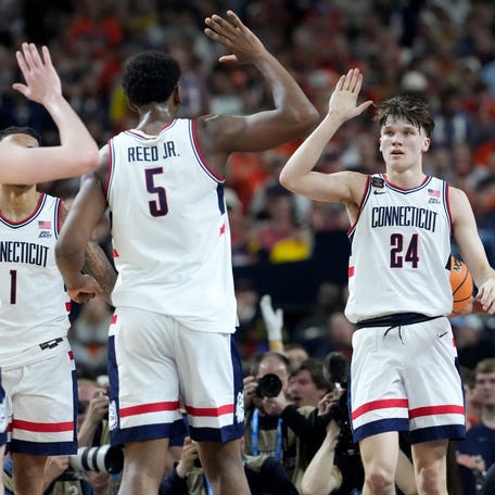 UConn Huskies guard Braylon Mullins (24) gets a high five after scoring Saturday, April 4, 2026, during a Final Four game against the Illinois Fighting Illini at Lucas Oil Stadium in Indianapolis.