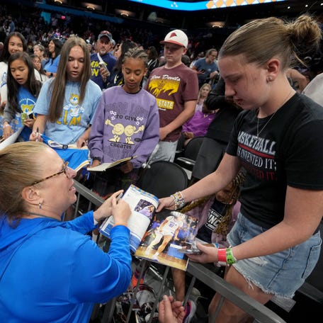 UCLA Bruins head coach Cori Close signs autographs for fans during the team's practice at the Mortgage Matchup Center in Phoenix on April 4, 2026, ahead of their NCAA National Championship matchup against the South Carolina Gamecocks on Sunday.