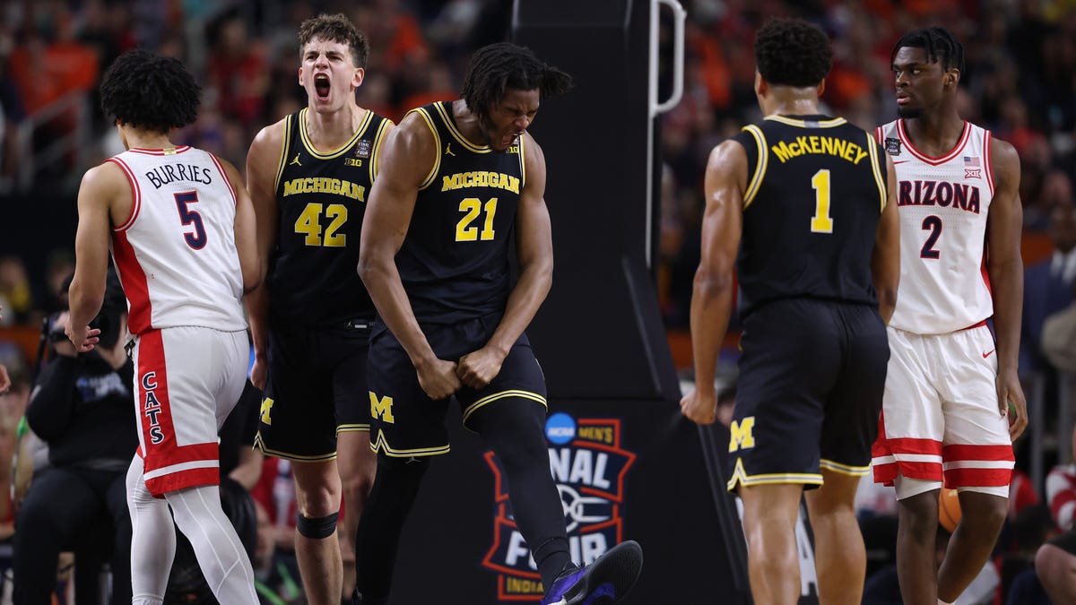INDIANAPOLIS, INDIANA - APRIL 04: Morez Johnson Jr. #21and Will Tschetter #42 of the Michigan Wolverines react with teammates against the Arizona Wildcats during the first half in the Final Four of the 2026 NCAA Men's Basketball Tournament at Lucas Oil Stadium on April 04, 2026 in Indianapolis, Indiana. (Photo by Patrick Smith/Getty Images)