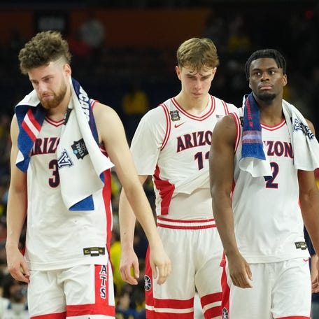 Arizona Wildcats guard Dwayne Aristode (2), Arizona Wildcats guard Anthony Dell'orso (3) and Arizona Wildcats guard Jackson Cook (11) react after losing to the Michigan Wolverines during a semifinal of the Final Four of the men's 2026 NCAA Tournament at Lucas Oil Stadium.