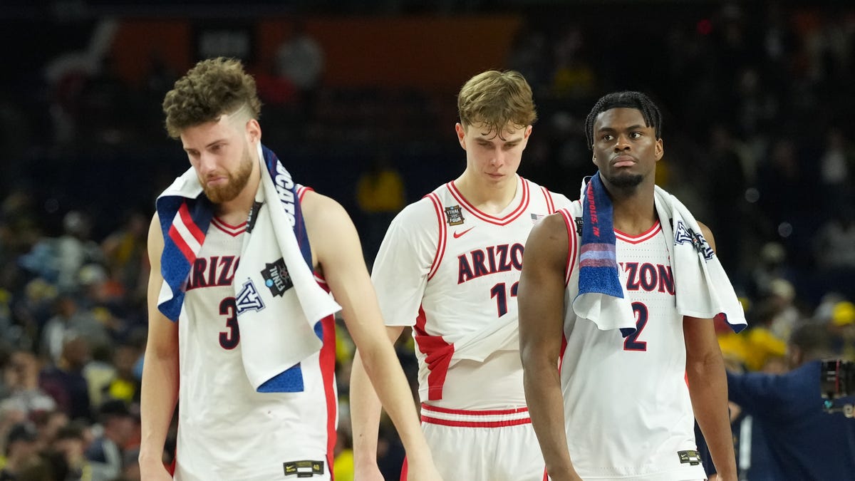 Arizona Wildcats guard Dwayne Aristode (2), Arizona Wildcats guard Anthony Dell'orso (3) and Arizona Wildcats guard Jackson Cook (11) react after losing to the Michigan Wolverines during a semifinal of the Final Four of the men's 2026 NCAA Tournament at Lucas Oil Stadium.