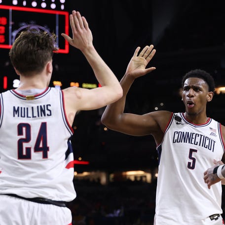 INDIANAPOLIS, INDIANA - APRIL 04: Tarris Reed Jr. #5 of the UConn Huskies celebrates a basket against the Illinois Fighting Illini during the first half in the Final Four of the 2026 NCAA Men's Basketball Tournament at Lucas Oil Stadium on April 04, 2026 in Indianapolis, Indiana. (Photo by Michael Reaves/Getty Images)