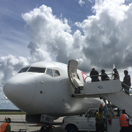 Passengers board a Caribbean Airlines flight in Georgetown, Guyana December 5, 2016.