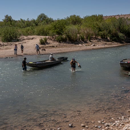 An American tourist wades south across the Rio Grande to Boquillas, Mexico, from Big Bend National Park at one of the few places where U.S. citizens can legally cross the international border on foot, March 23, 2026.