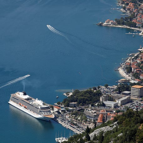 A view of the cruise ship, Viking Venus, carrying passengers to Montenegro, docked in front of Old Town of Kotor, Montenegro on July 17, 2021.