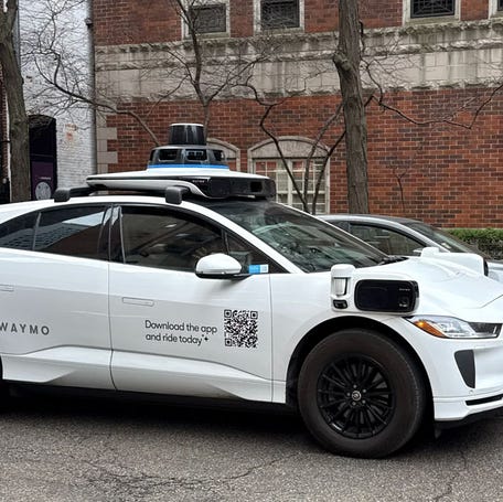 A Waymo vehicle drives through Chicago’s Near North Side on March 20 as the company begins testing and mapping the city.
