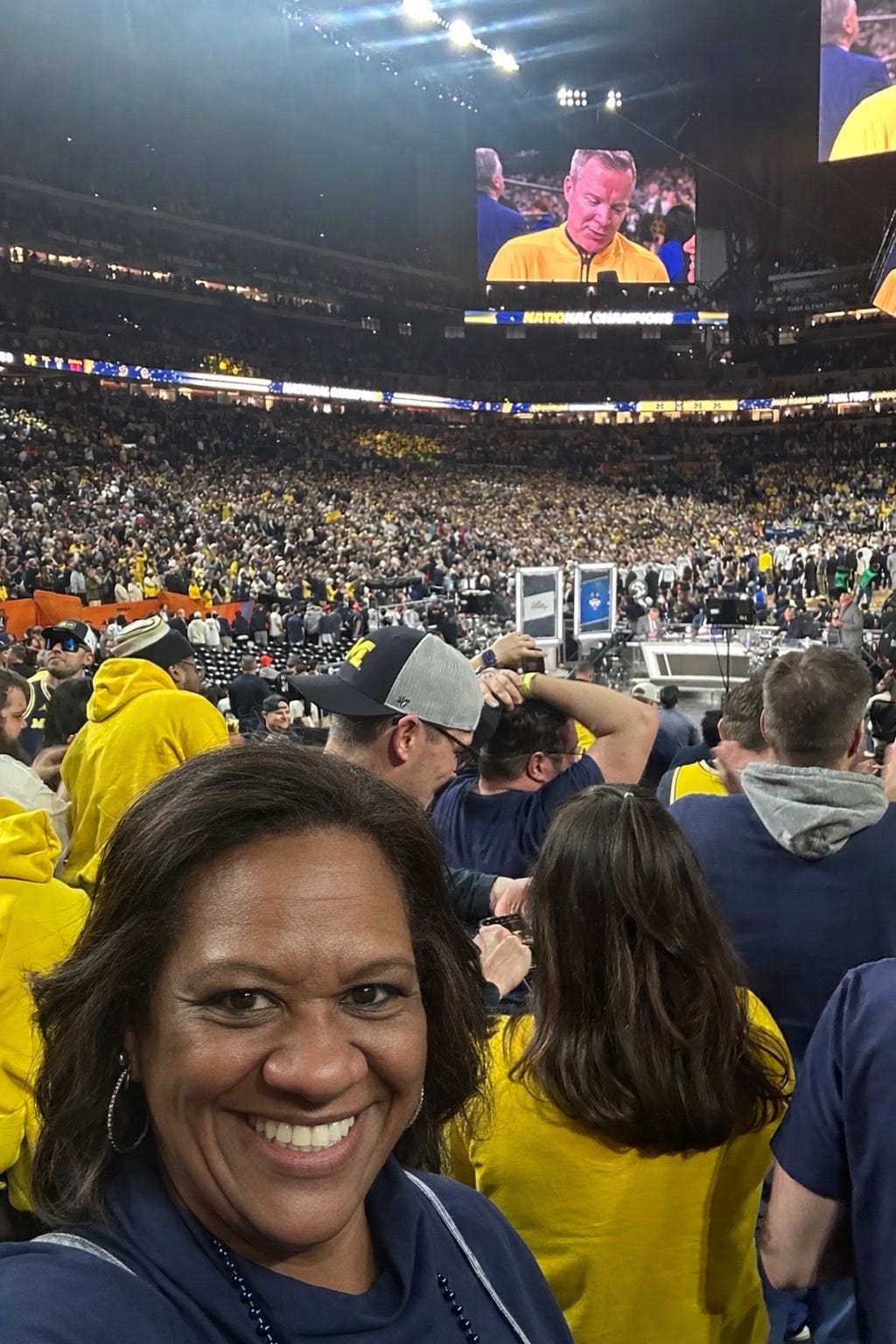 https://www.gannett-cdn.com/authoring/authoring-images/2026/04/08/PDTF/89525338007-susan-holmes-watching-michigan-win-the-national-championship-in-indianapolis.jpg?auto=webp&crop=1022,575,x0,y869&format=pjpg&width=1200